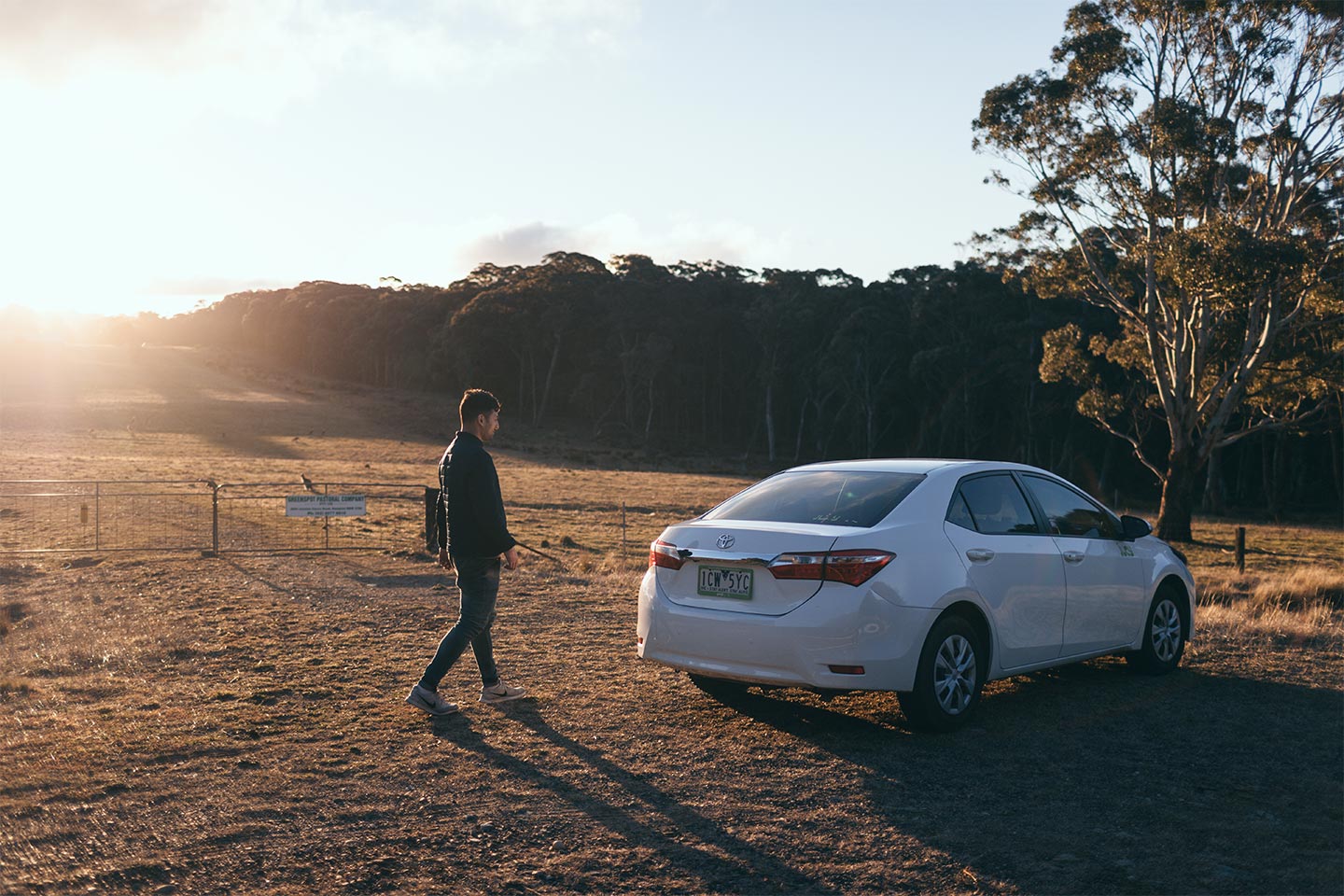 man walks back to sedan