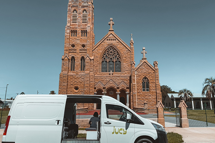 JUCY Coaster campervan outside St Mary’s Church