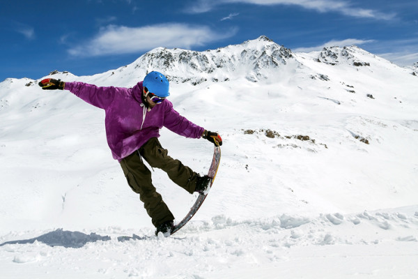 Person doing tricks on snowboard