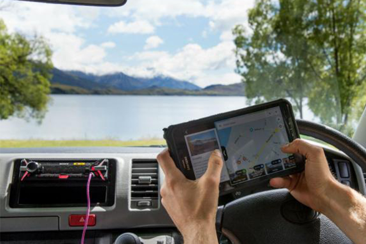 Person looking at tablet in campervan