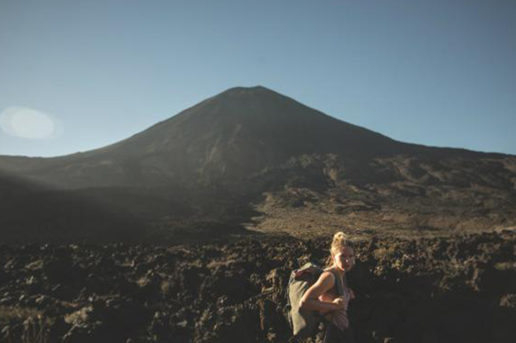 Woman hiking through hills