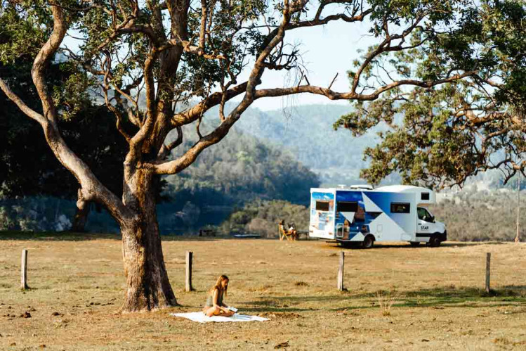 Star RV motorhome parked in field